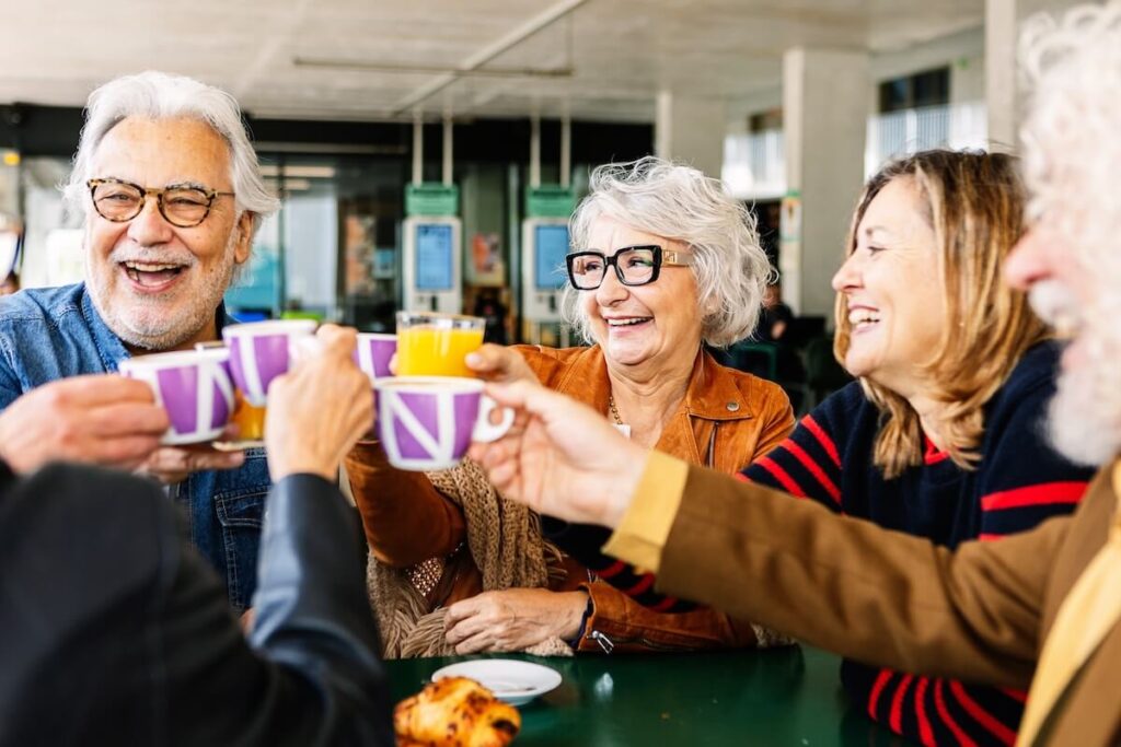 Happy group of senior people enjoying coffee at cafeteria bar. (1)